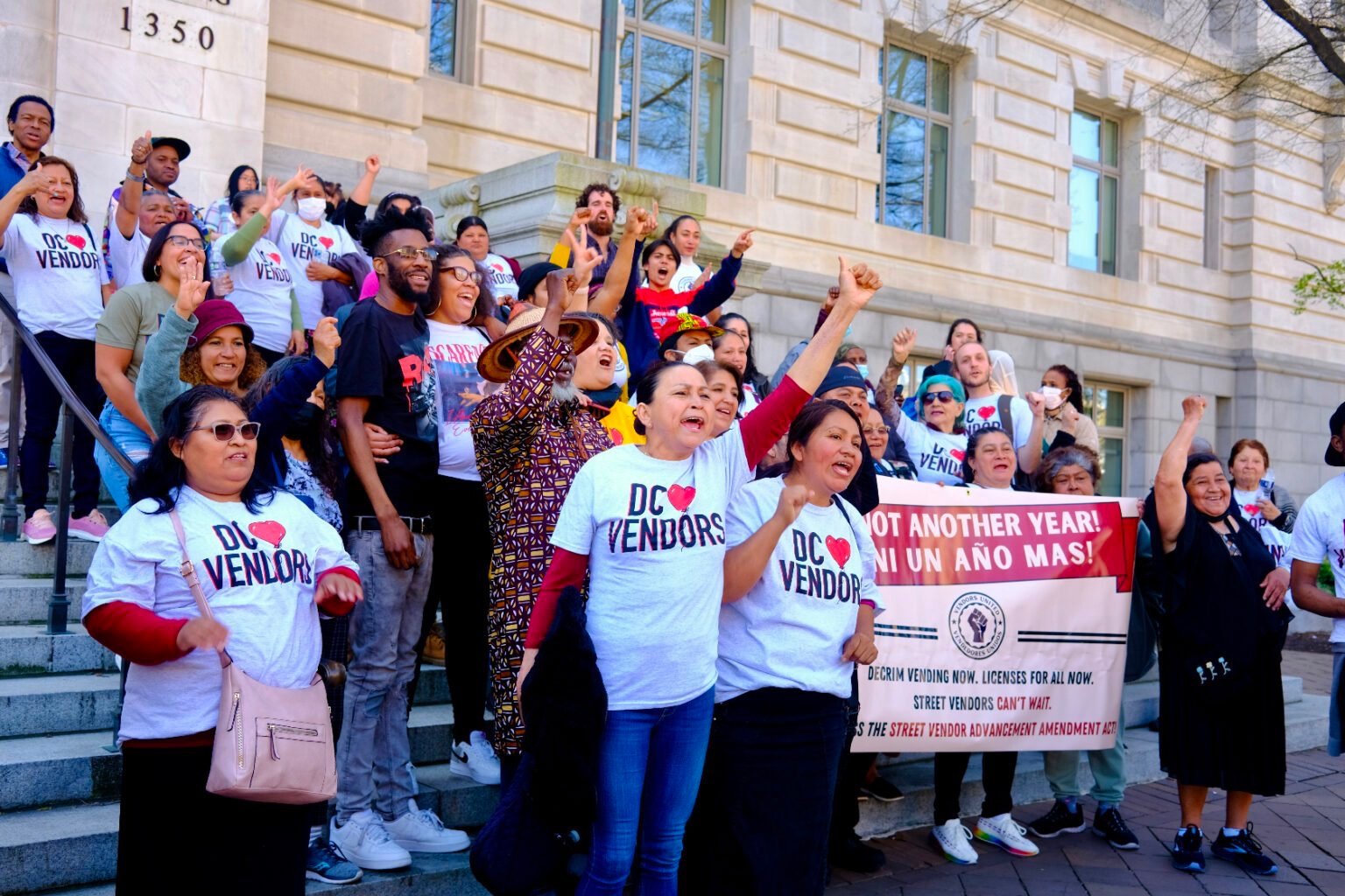 Street vendors rally together on the steps of a building. Street vendors rally together on the steps of a building.